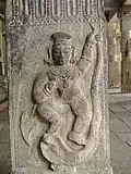 Krishna dancing over snake Kaliya at the sand-covered temple ruins in Talakkadu, Karnataka, India.