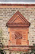 "delicate brick panels of sunflowers"[4]