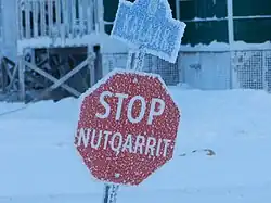 Octagonal stop sign reading STOP / NUTQARRIT