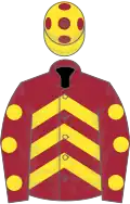 Maroon, yellow chevrons and spots on sleeves, yellow cap, maroon spots