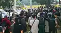 Protestors enter the grounds of the House of Representatives after the right gate was broken down during a demonstration on the regional election bill