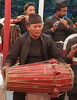 Newar man playing Pakhawaaja (Newar drum)