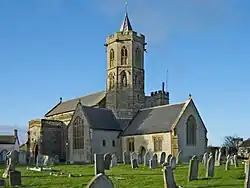 Stone building with Octagonal tower topped by a short spirelet.