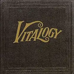 A plain black background with a gold foil title in script