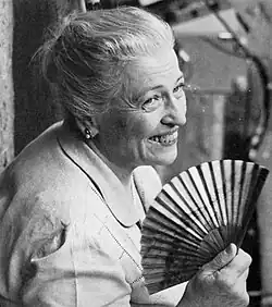 A black-and-white photo of Pearl S. Buck holding a hand fan