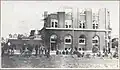 People in front of damaged building