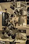 35mm film threaded in the mechanism (white spacing), through the picture gate and analog optical audio head.