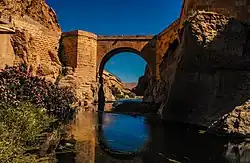 below the bridge