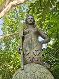 Detail of one of the four statues with its oar.