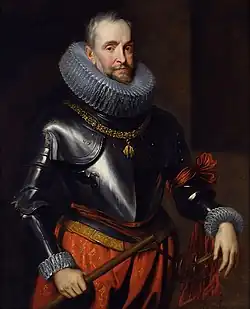 Color portrait of a middle aged man wearing a metallic coat of armour on his upper body and a maroon red skirt on his lower body