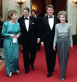 The Reagans and the Clintons walking a red carpet during the 1987 Dinner Honoring the Nation's Governors