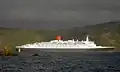 QE2 slips out the entrance in a following breeze, 2006