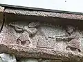 A large block of stone is shaped.