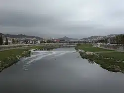 View of the river Besòs as it passes through the municipality. In the later course of the river the "Riverside Park of Besòs" was created and has become an important public open space.