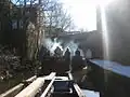 Wooden boat convoy picking up recyclables on Ashton Canal