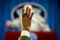 Reporters raise their hand to signal that they wish to ask a question.