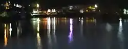 Reflections of the rowing clubs around the lake at night