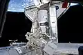 The docked Discovery and Dextre are featured in this photograph.