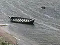 Viking Museum Foteviken in Skanör. Viking boats in the water in front of the settlement