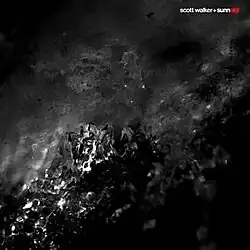 A dark photo of what appears to be two fluids mixing
