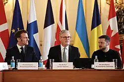 The Ukrainian flag being decorated at a 2025 conference of European leaders with a relatively light shade of blue, especially when being compared to other European national flags