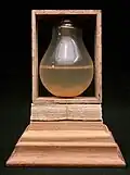 "Light Bulb and Paper": paper, wood, bulb, twine. 61/4 x 4 3/4 x 3 3/8 inches. 1996.