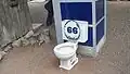 Toilet and phone booth displayed for humorous effect in the garden
