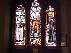 Stained glass west window depicting Óscar Romero, Pier Giorgio Frassati and André Bessette