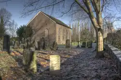 A plain brick church with tall Georgian-style windows