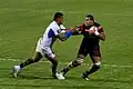 Fend by Edwin Maka during a rugby union game.