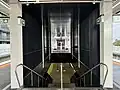 The staircase from the platforms leading down to the mid-level concourse, July 2024