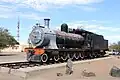 Steam locomotive of South African Railways in front of the station building