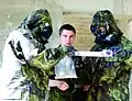 Soldiers from Texas prepare a sample for transport to the testing lab while a Soldier from the Czech Republic looks on.