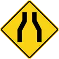 Road narrows on both sides