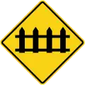 Railway crossing ahead that is protected by automatic gates