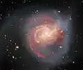 The peculiar galaxy NGC 3256 dominates this image from the NASA/ESA/CSA James Webb Space Telescope.