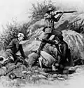 In the pits An officer hands a wounded soldier water as another man drinks from a pool, while a third prepares to fire his rifle.