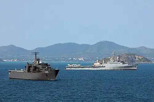 RSS Resolution at anchor in the Gulf of Thailand, with USS&nbsp;Denver passing behind during Cobra Gold '11.