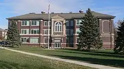 Three-story brick building with vaguely neoclassical details