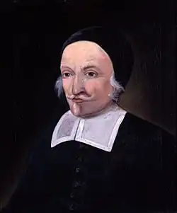 A painting of a man with a white moustache and small beard. He is wearing a skull cap and the bib of a colonial-era minister.