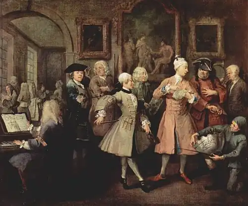 A Rake's Progress: II – The Levée by William Hogarth, c. 1732–1734; Figg stands third from the left, between the fencing master and the dance instructor, wearing a white wig and holding two quarterstaffs.