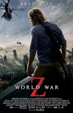 A man standing on a rooftop, his back to the viewer, and a gun strapped over his shoulder. He is looking out over a devastated city. A helicopter flies overhead nearby.