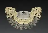 Moche nose ornament made from silver and gold-silver alloy, inlaid with malachite, now at the Cleveland Museum of Art, United States.