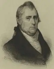 Black and white print of solemn looking man in 18th century civilian dress with dark coat and white shirt