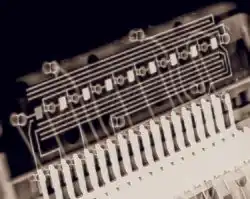 Eight small rectangular blobs, which are the digits, connected by fine hair-like wires to tracks along a circuit board