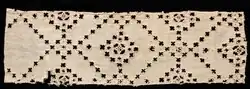 fragment of old fabric 14 x 45.4 cm (5 1/2 x 17 7/8 in.) with a diagonal pattern of fabric cut away
